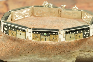 Stunning Bracelet featuring a Beautiful Starry Night Design with Pueblos and Monument Valley Design. Genuine Picture Jasper and Black Jade inlaid in Sterling Silver Bracelet. Beautiful Fire and Ice Lab Opal Moon and Shooting Star! Reversible Bracelet with a Contemporary Sterling Silver Design. Designed by Navajo Artist Calvin Begay. Signed by the artist.